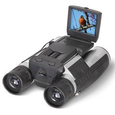 a laptop computer sitting on top of a binoculars