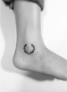 a woman's foot with a small tattoo on it