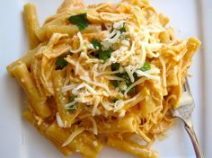 a white plate topped with pasta and cheese