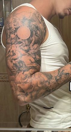 a man with his arm covered in tattoos