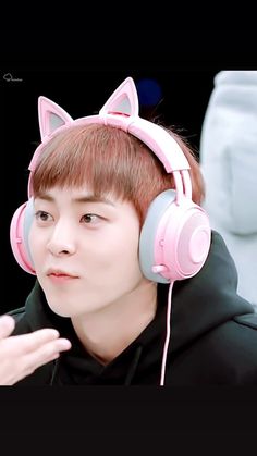 a young man wearing headphones with cat ears