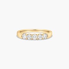 a yellow gold ring with three diamonds