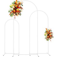 three white metal flower stands with orange and yellow flowers on them, each holding an individual's bouquet