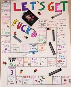 a board game with words written on it and some crayons in the background