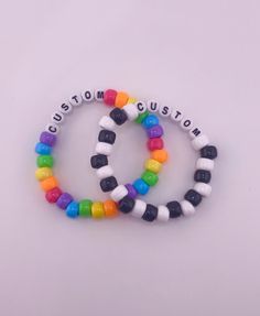 These custom kandi singles are perfect for any kandi kid, scene lover, or rave goer! Every bracelet is completely customizable, which means that you get to decide sizing, colors, letters, and numbers!  All bracelets are made with cloth-covered stretch cord, which assures that your jewlery will stretch nicely around the hand. the cloth covering will keep the quality at top shape for as long as possible, and prevent any wear and tear. Customization Instructions All available bead colors are listed in the images above. Please indicate which color beads you'd like within the note of your order. Please also indicate which string color you'd like.  BE SPECIFIC! Include color order, pattern, or any extra customization instructions with as much detail as possible. Letter and Number Beads  All word White Customizable Novelty Jewelry, Customizable Novelty White Jewelry, Customizable White Novelty Jewelry, Customizable Fun White Jewelry, Fun Multicolor Customizable Jewelry, Fun Customizable White Jewelry, Customizable Adjustable Rainbow Jewelry, White Handmade Beaded Bracelets For Rave, Customizable Multicolor Round Beads Wristband