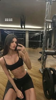 a woman taking a selfie in the gym