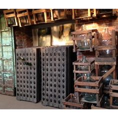 several wooden crates stacked on top of each other in front of a brick wall and window