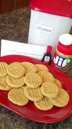 some cookies are on a red plate next to a container