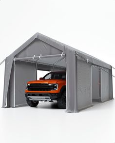 an orange truck is parked in front of a gray structure with the door open to show it's interior