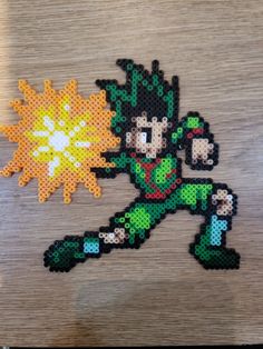 an image of a pixel art piece made out of beads on a wooden table with a lightening effect