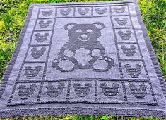 a crocheted teddy bear rug on the grass