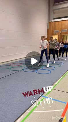 a group of people standing on top of a gym floor