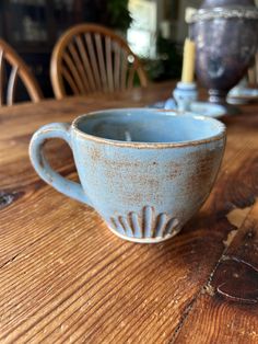 a blue cup sitting on top of a wooden table