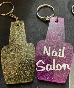 two keychains that say nail salon and one has a bottle opener on it