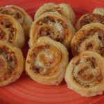 a red plate topped with pastries on top of a table