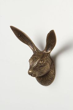 a bronze colored rabbit head on a white background