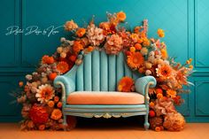 a blue chair with flowers on the back and an orange pillow in front of it