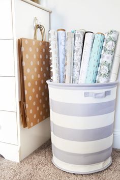 a white and gray striped bin with papers in it