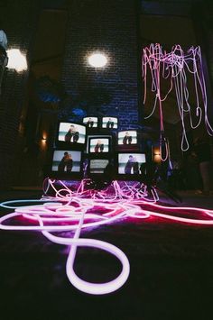 some neon lights in front of a building