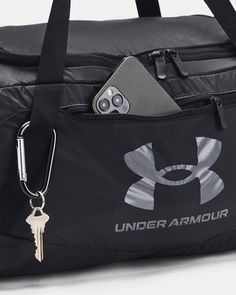 the under armour bag has a keychain attached to it's front pocket