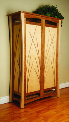 a wooden cabinet sitting on top of a hard wood floor next to a green plant