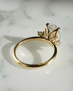 a diamond ring sitting on top of a table