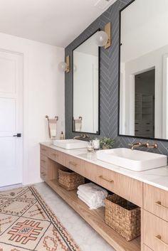 a bathroom with two sinks and mirrors in it