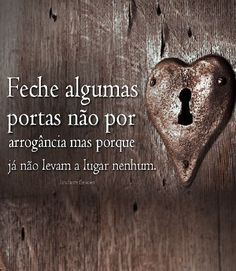 a heart shaped lock on a wooden door with spanish words written in the center and below it