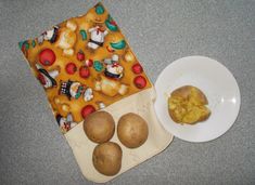 potatoes and other food items are on the counter next to a plate with an oven mitt