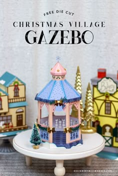 a christmas village gazebo is shown on a table