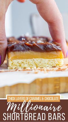 a hand reaching for a piece of chocolate caramel shortbread bars