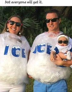 a man and woman holding a baby wrapped in plastic bags with the word ice on them