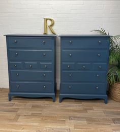 two blue dressers side by side with the letter r on top