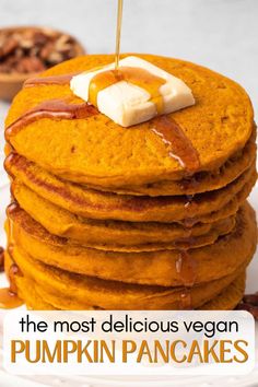 the most delicious vegan pumpkin pancakes with maple syrup and butter on top are ready to be eaten