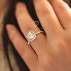 a woman's hand with a diamond ring on it