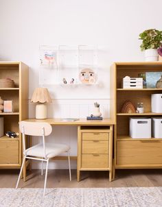 a wooden desk sitting next to a white chair