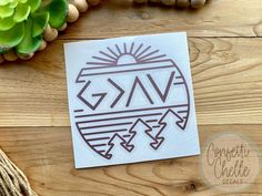 a sticker with the word gav on it sitting next to a plant and string