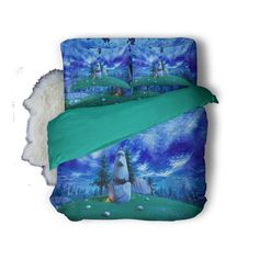 an image of a bed set with blue and green designs on the sheets, pillowcases and comforter