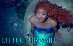 the little mermaid is posing for a photo