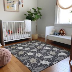 a baby's room with a crib, chair and rug on the floor