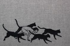 a black and white photo of cats chasing a man