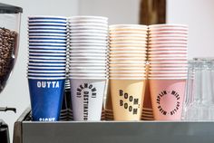 coffee cups are lined up next to each other