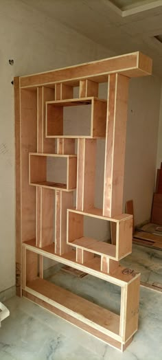 an unfinished room with wooden shelves on the floor