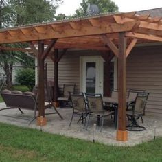 a covered patio with chairs and tables outside