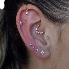 a woman with ear piercings that have diamonds on them