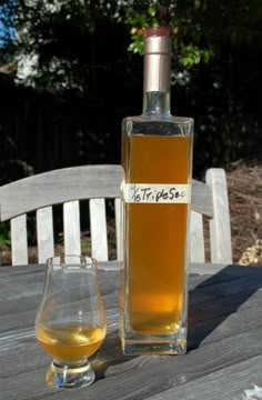 a bottle of alcohol sitting on top of a wooden table