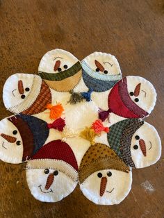 a group of snowmen with hats on top of each other in the shape of a circle