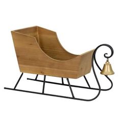 a small wooden sleigh with a bell on the side and black metal stand