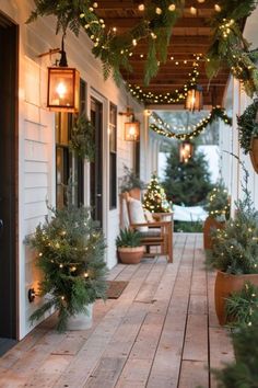 the porch is decorated with christmas lights and potted plants