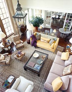 an overhead view of a living room with couches, chairs and tables in it